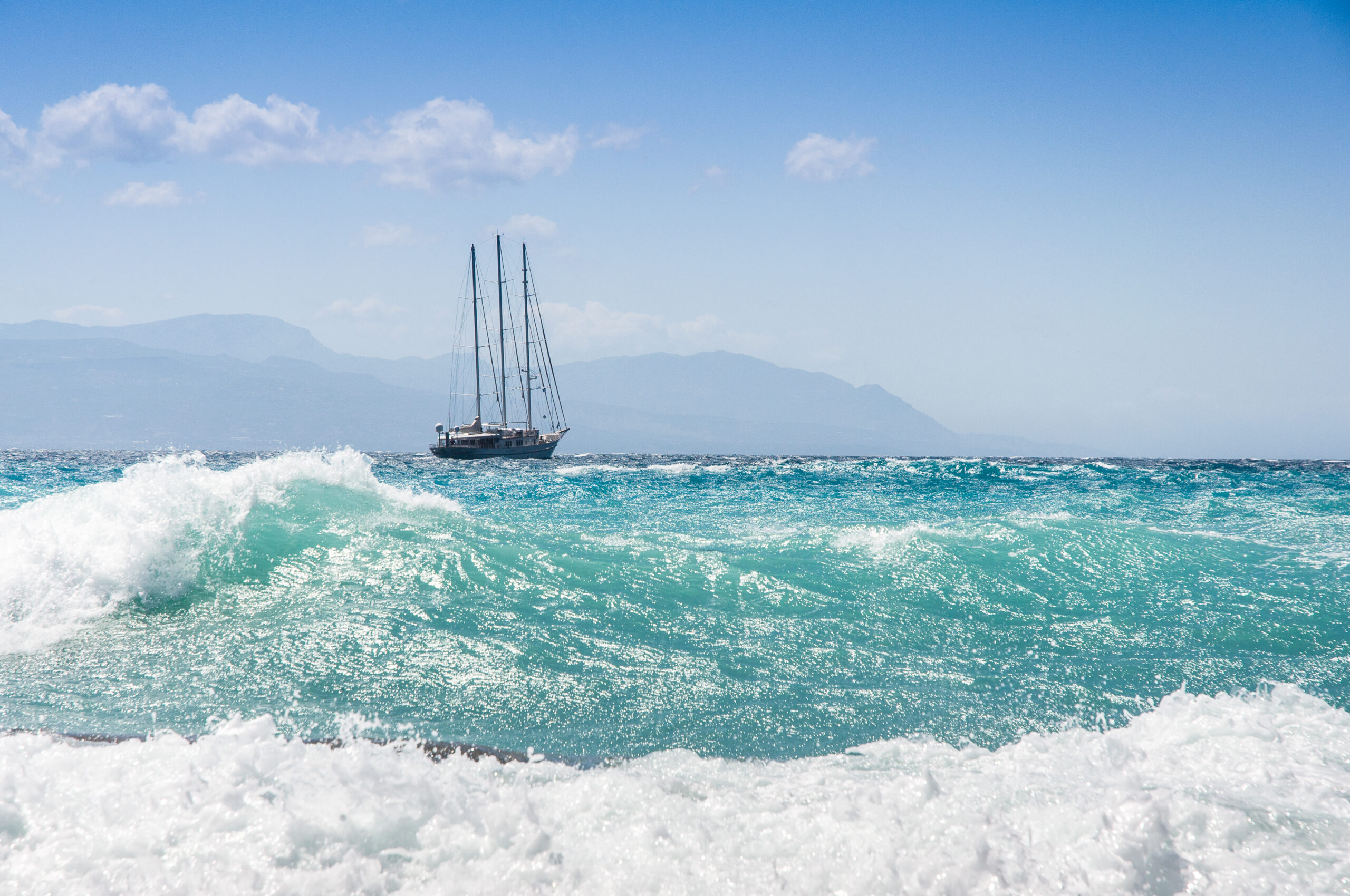 A sailship battling rough seas during a fierce storm.